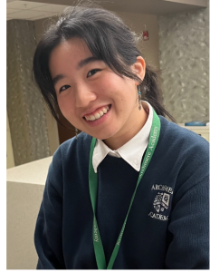 Brianna smiling by the lockers before her Mock Trial meeting. 
